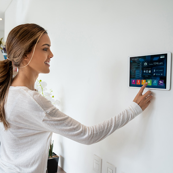 Woman activating a lock system at her smart home